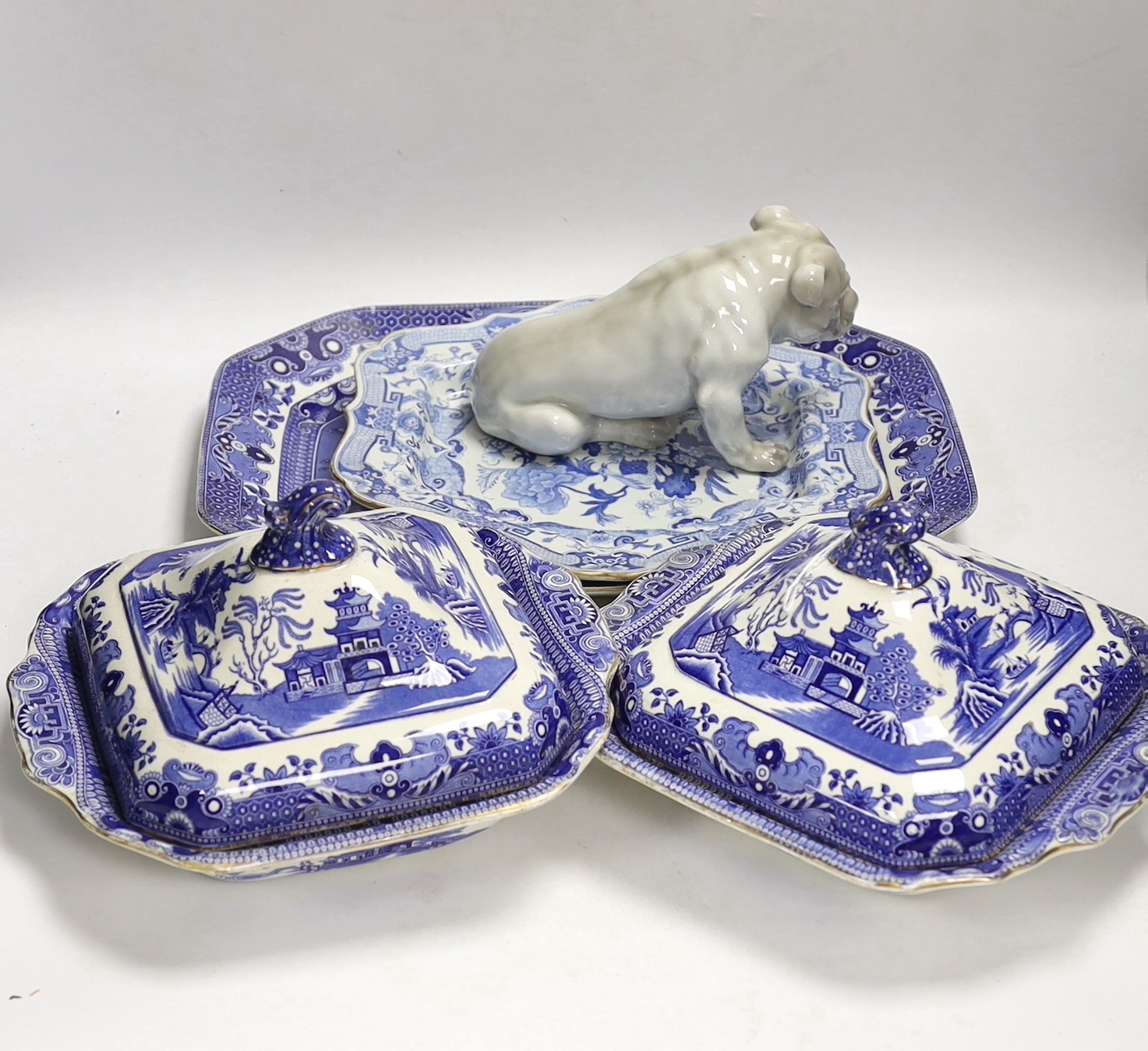 A Mason's stoneware blue and white plate, 2 tureens and a serving dish and a German model of a pug dog